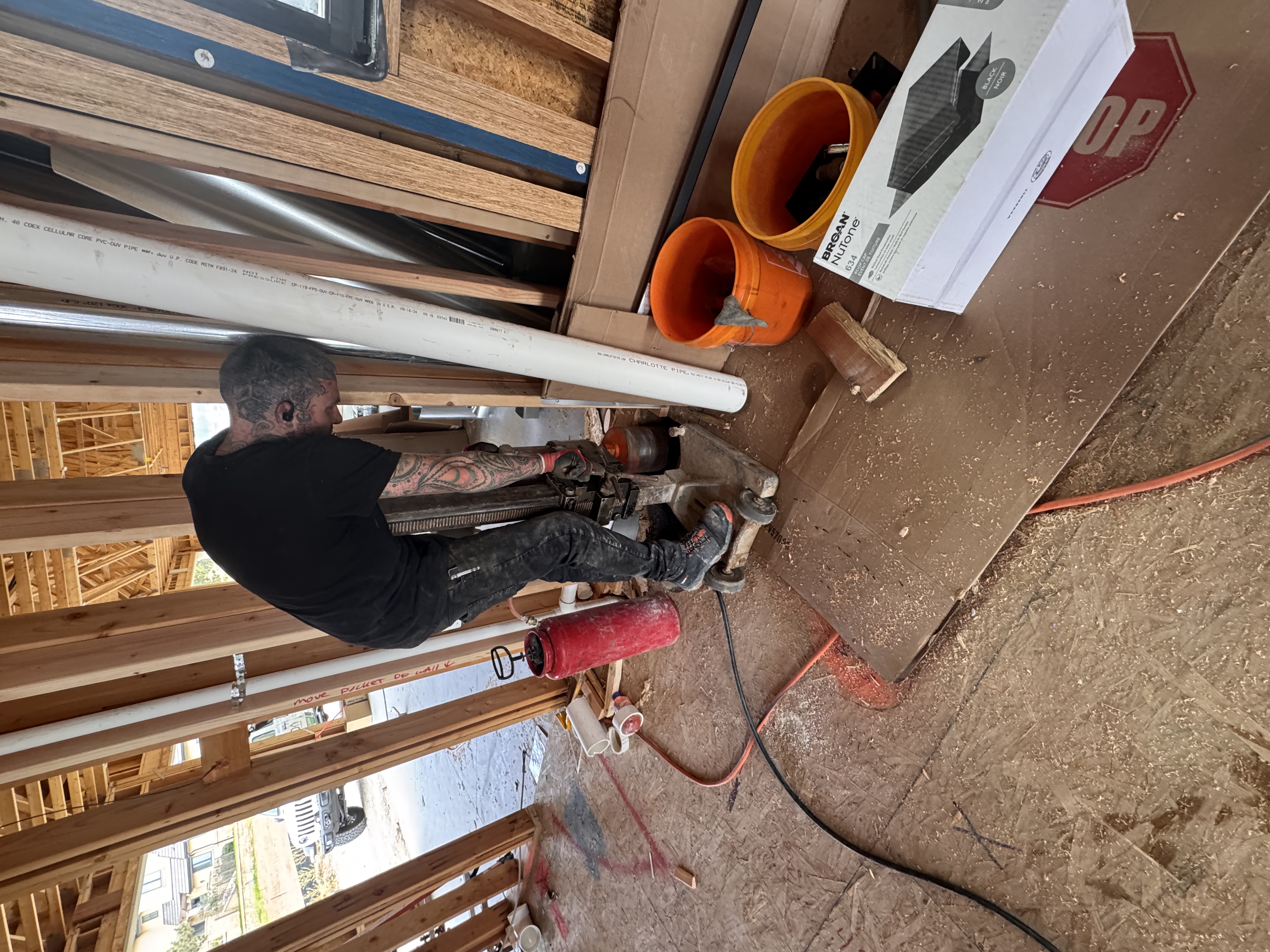 Custom Radon technician core-drilling a slab to install a radon system